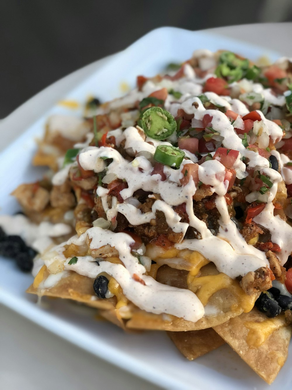 Realistic photo of crispy tortilla chips with guacamole, queso, and salsa